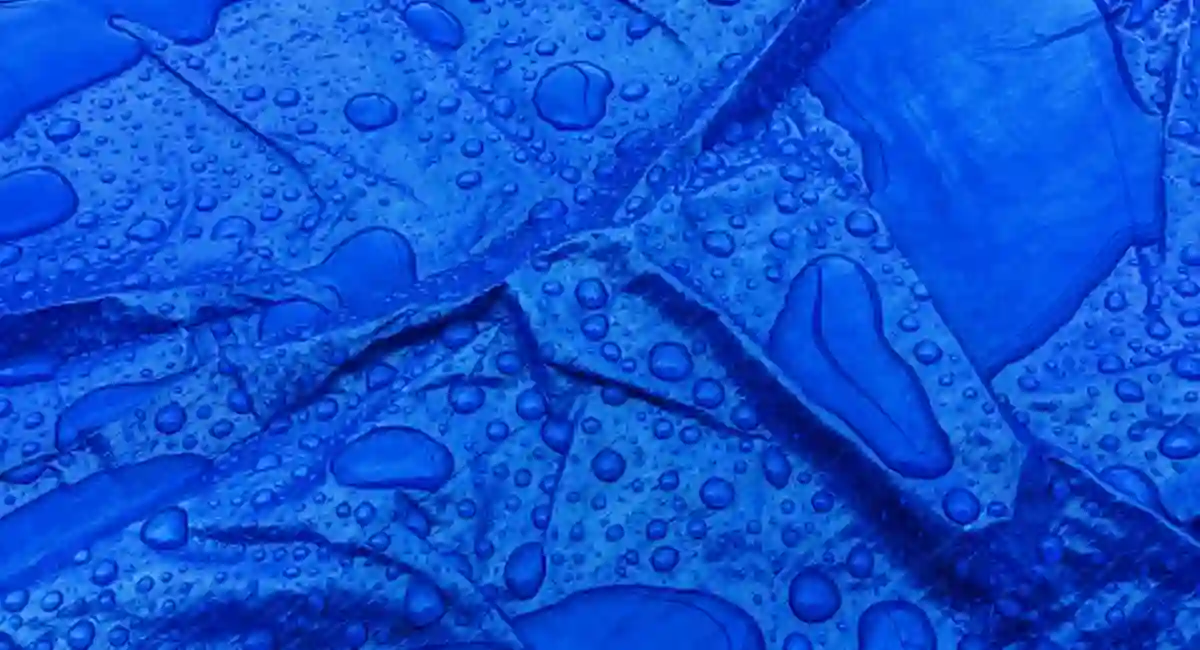 Droplets of rainwater on the blue tarp