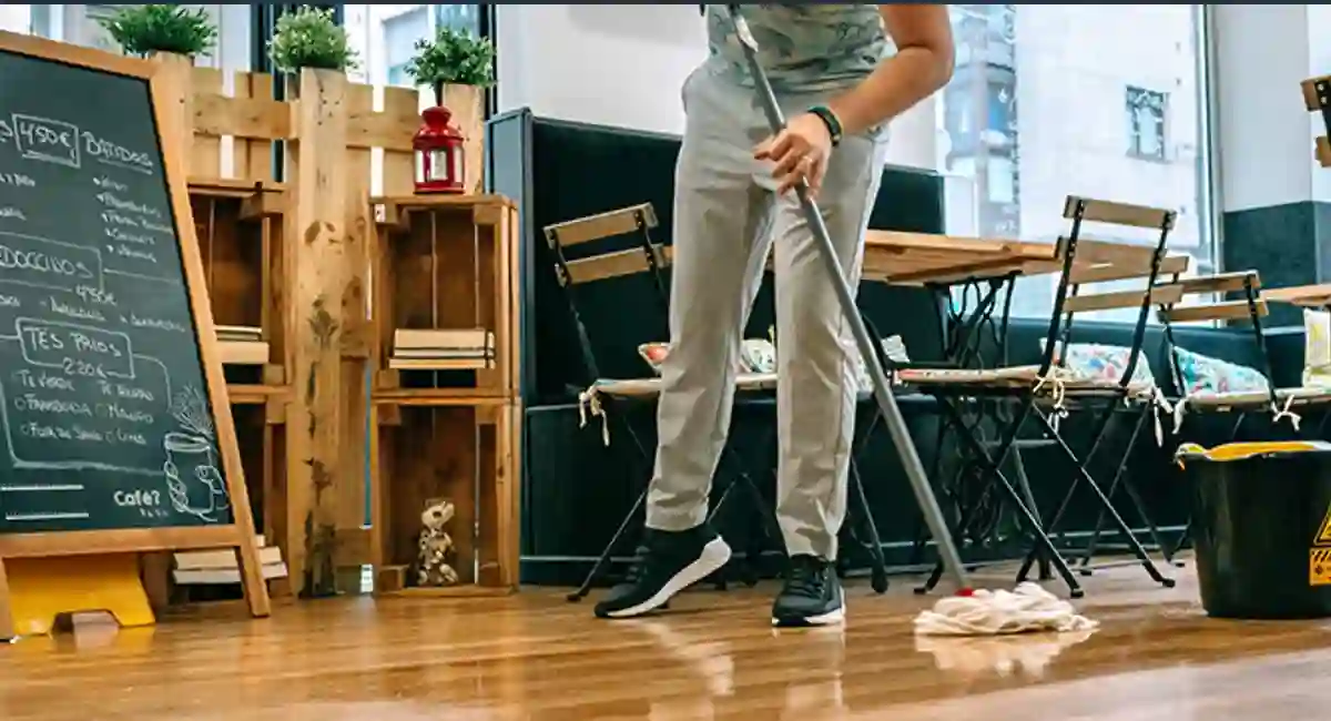 man mopping a cafe