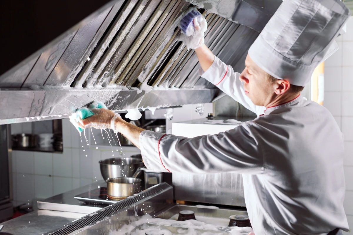 Chef cleaning down the kitchen
