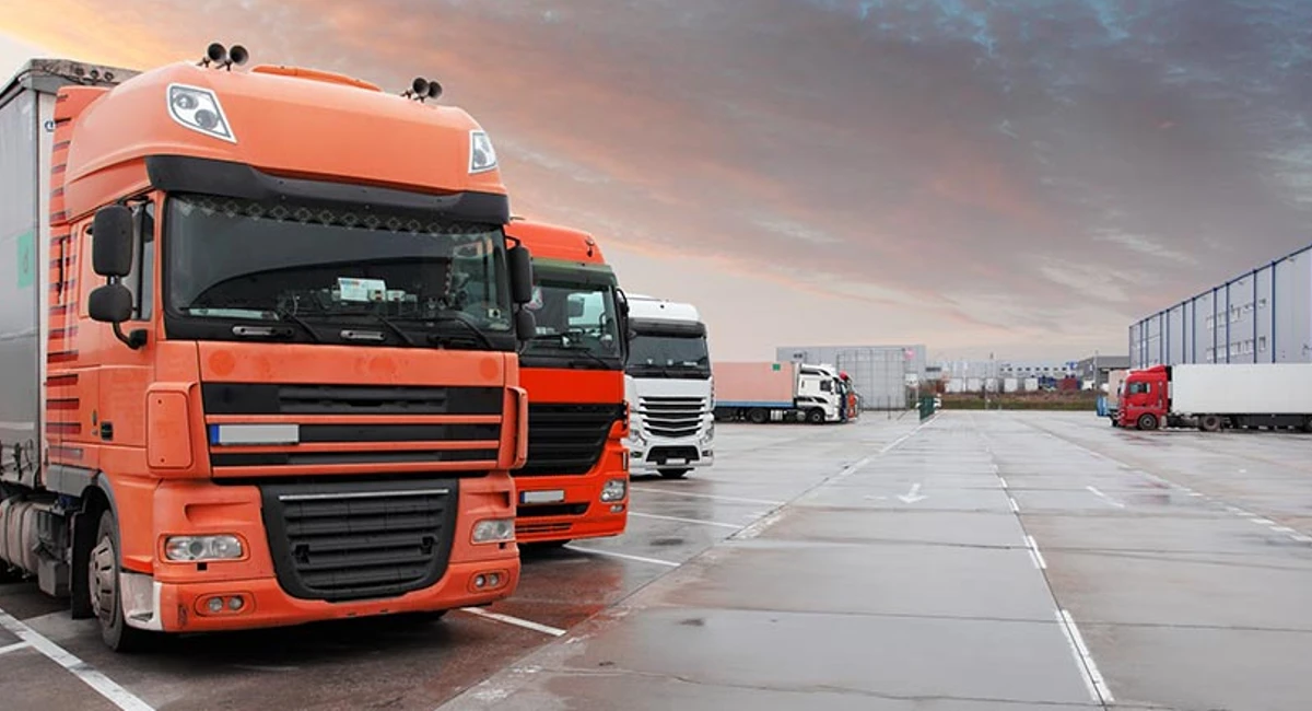commercial vehicles parked outside of a  warehouse