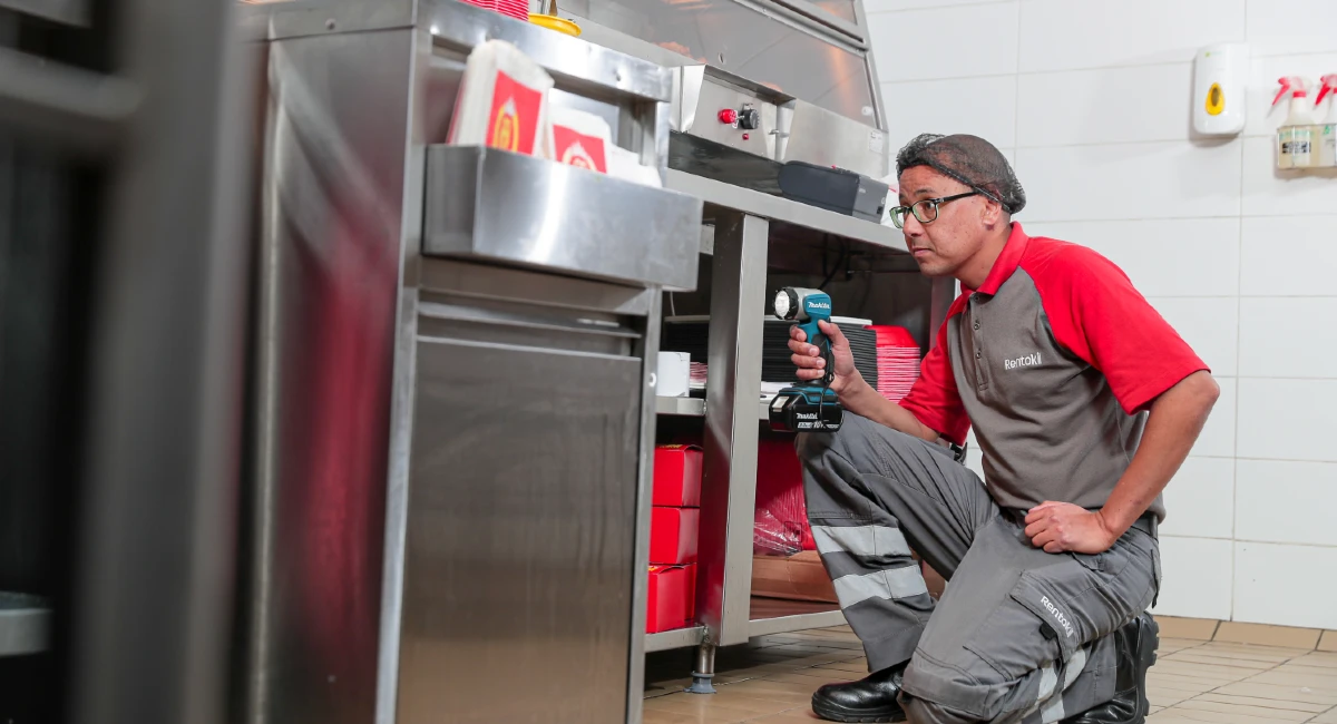 a Rentokil technician inspects a commercial kitchen