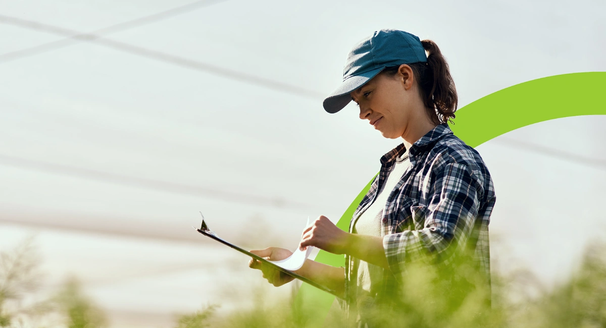 Woman standing outside with a clipboard
